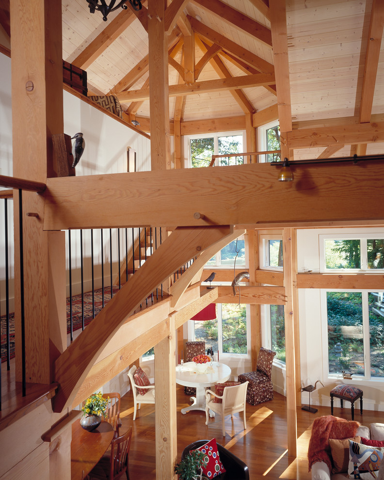 This is an example of a rustic wood l-shaped staircase in Boston with wood risers.