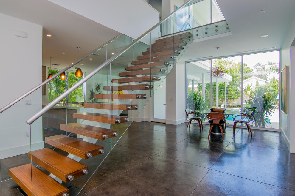 Inspiration for a large contemporary wood straight glass railing staircase in Tampa.