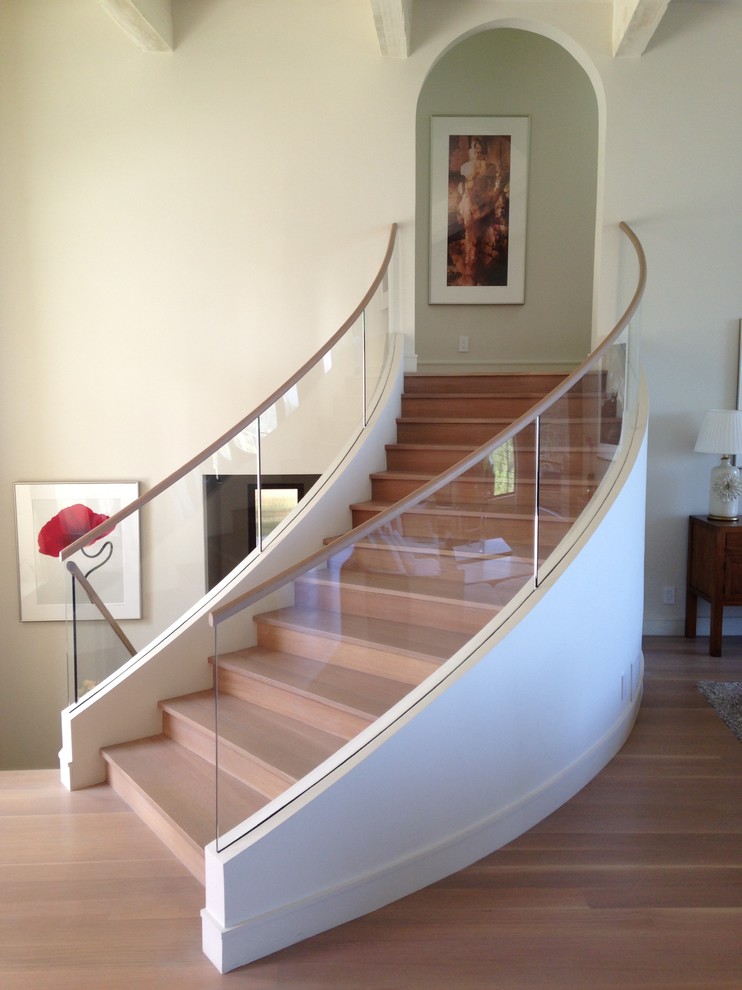 Medium sized modern wood curved staircase in San Francisco with wood risers and feature lighting.