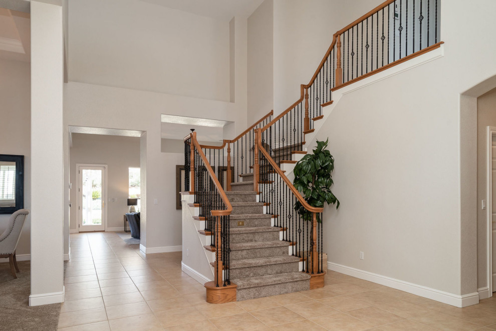 Example of a mid-sized classic carpeted l-shaped wood railing staircase design in Sacramento with carpeted risers