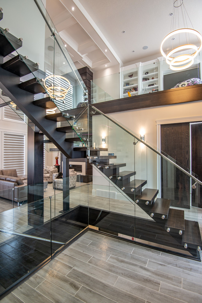 Inspiration for a large classic wood l-shaped glass railing staircase in Other with open risers.