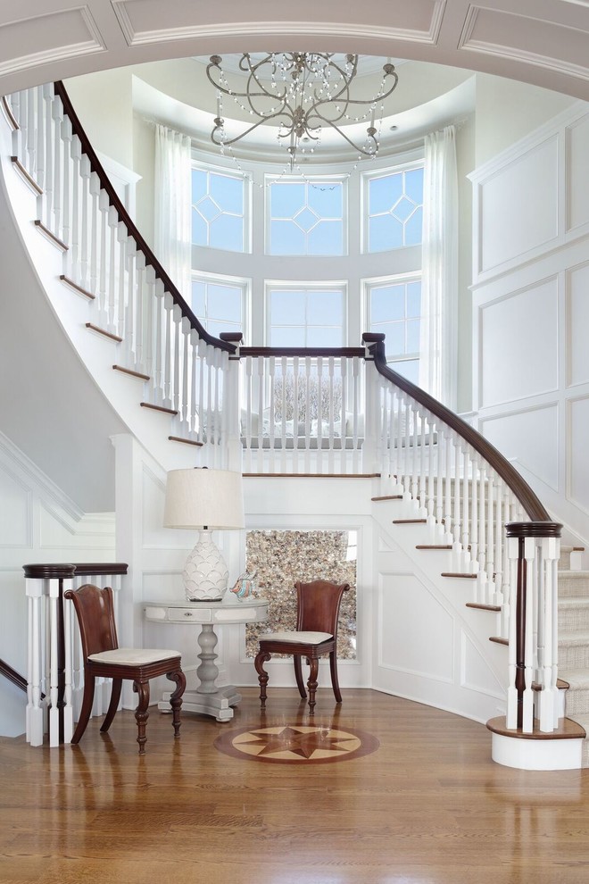 Inspiration for a classic wood curved wood railing staircase in New York with painted wood risers and feature lighting.