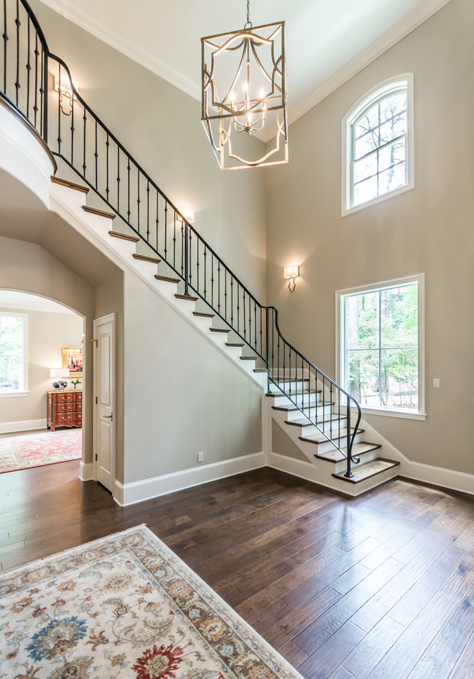 Staircase - large transitional wooden l-shaped staircase idea in New Orleans with painted risers