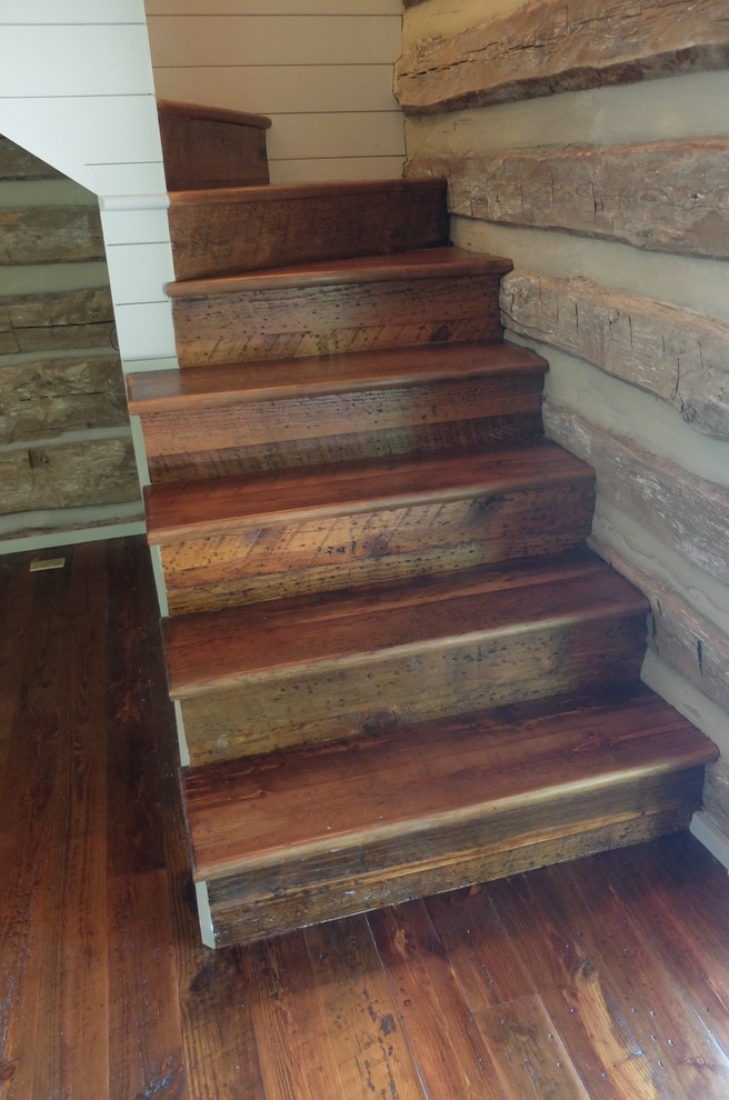 Small rustic wood curved staircase in Raleigh with wood risers.