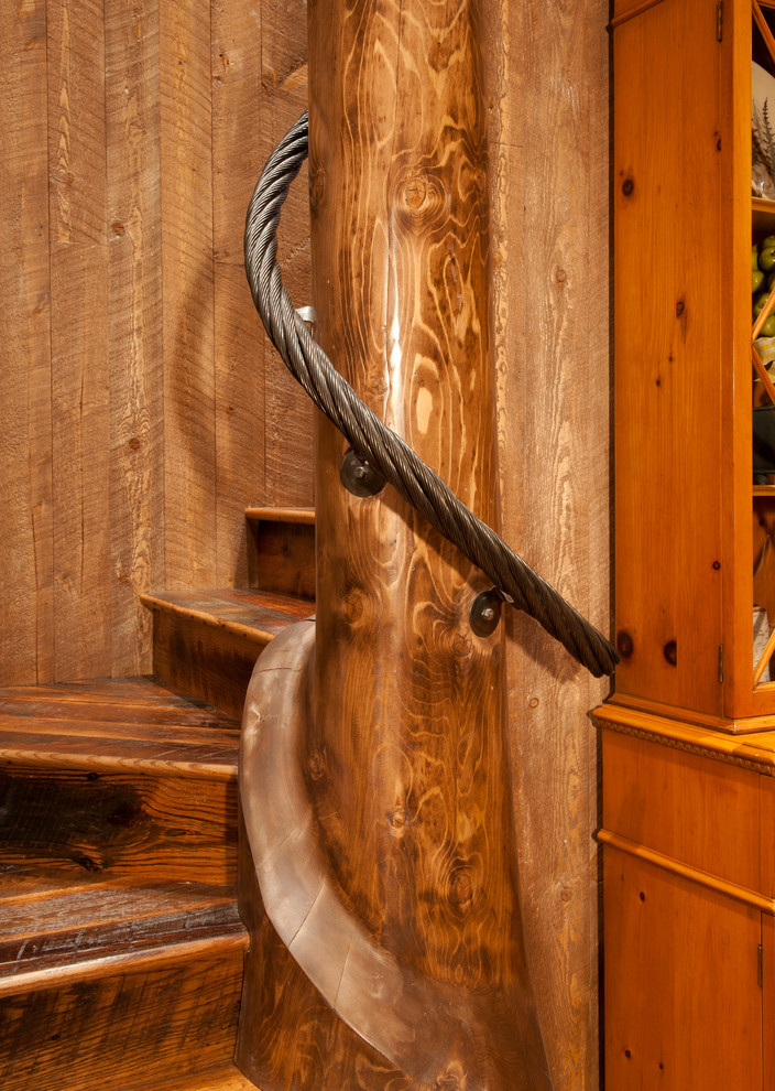 Small mountain style wooden spiral staircase photo in Denver with wooden risers