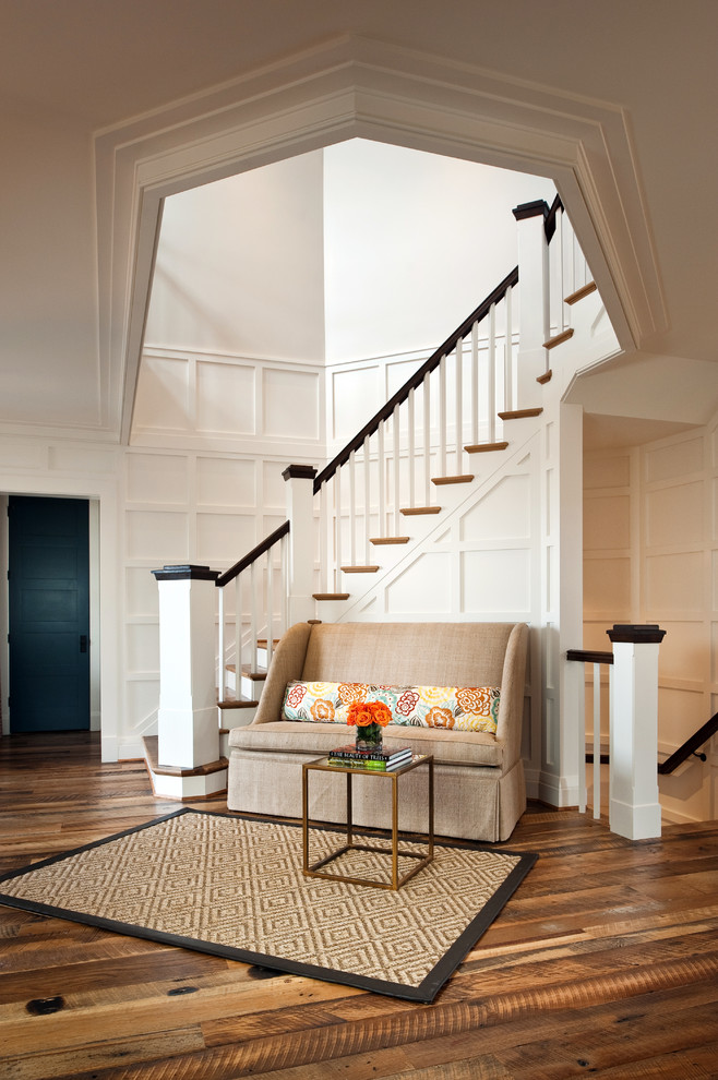 Photo of a traditional wood curved staircase in Richmond with painted wood risers and feature lighting.