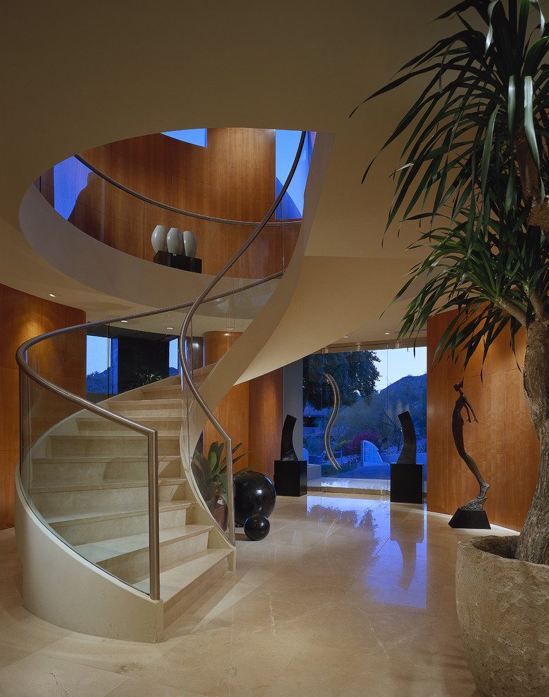 Staircase - contemporary curved glass railing staircase idea in Phoenix