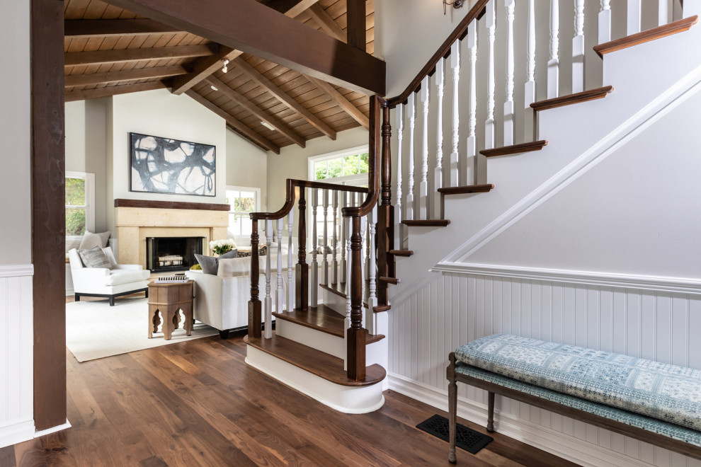 Large coastal staircase in Los Angeles with wainscoting.