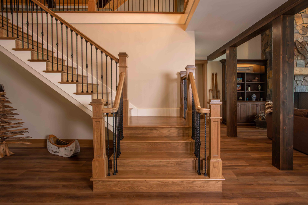 Inspiration for a large wooden l-shaped mixed material railing staircase remodel in Other with wooden risers