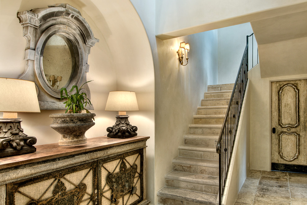 Design ideas for a mediterranean u-shaped staircase in Houston with feature lighting.