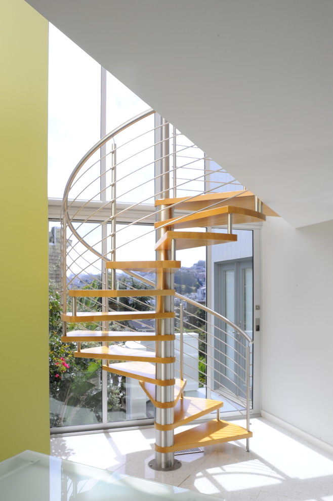 Photo of a contemporary wood spiral staircase in San Francisco with open risers.