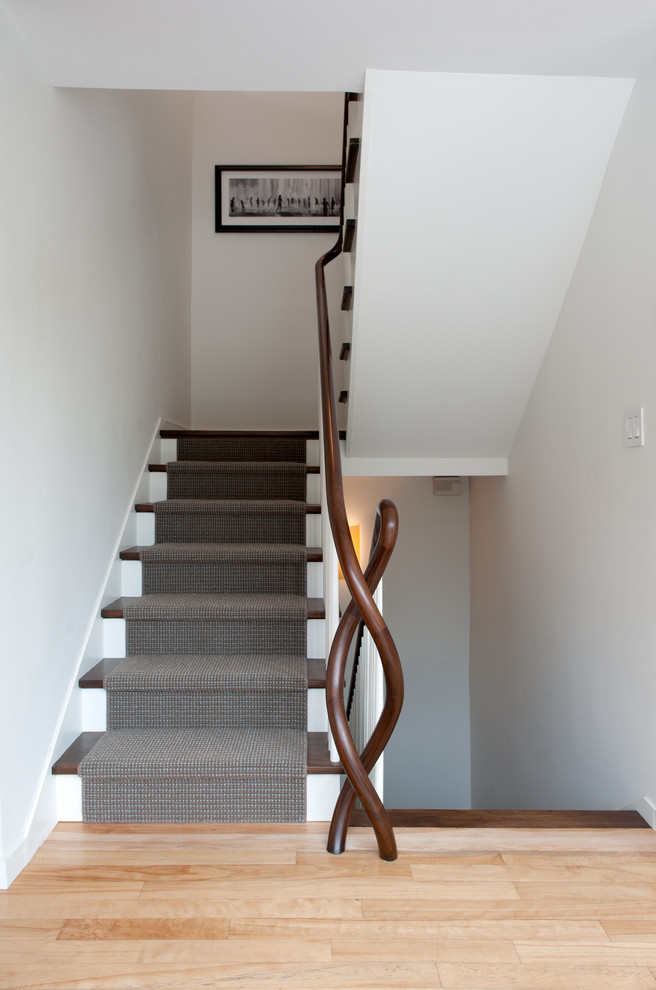 Example of a trendy wooden staircase design in Burlington