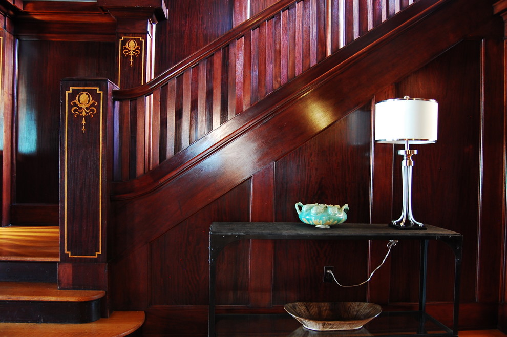 This is an example of a traditional staircase in New York with feature lighting.