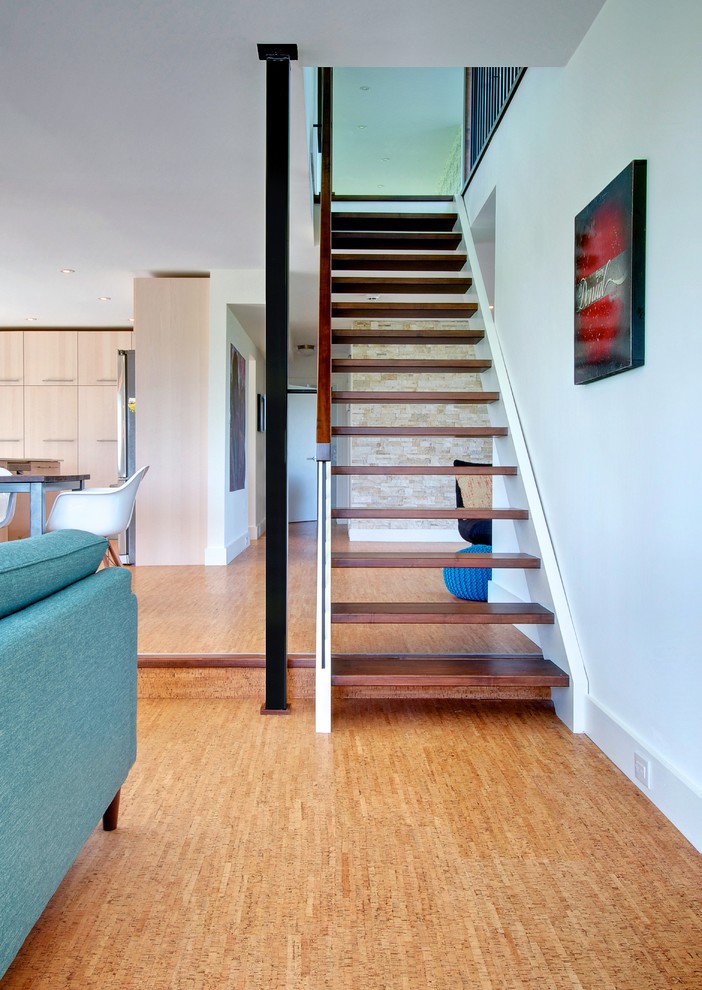 This is an example of a contemporary wood staircase in Toronto with open risers.