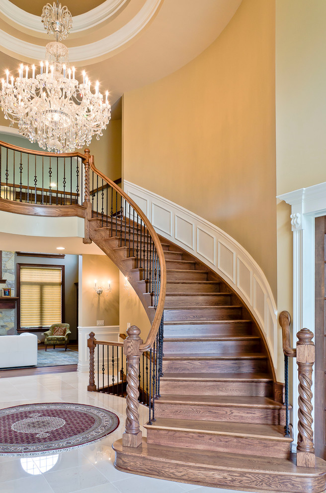 Photo of a traditional wood curved staircase in Other with wood risers.