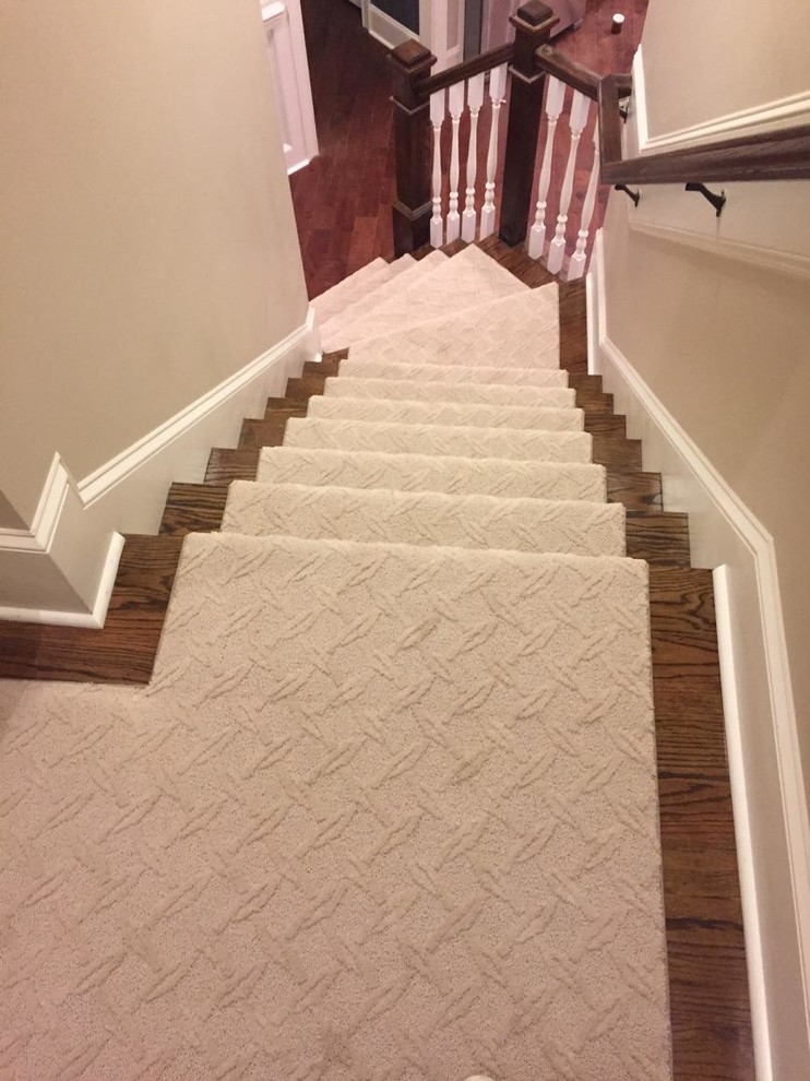 Medium sized classic wood l-shaped staircase in Raleigh with painted wood risers.