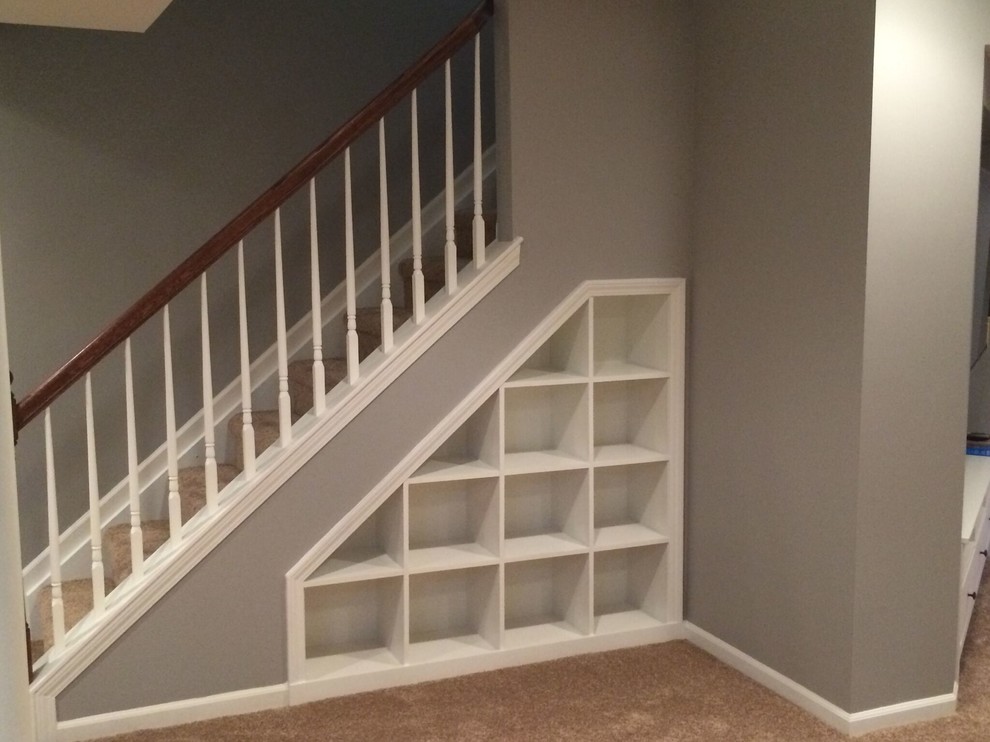 Medium sized classic carpeted straight wood railing staircase in Orange County with carpeted risers.