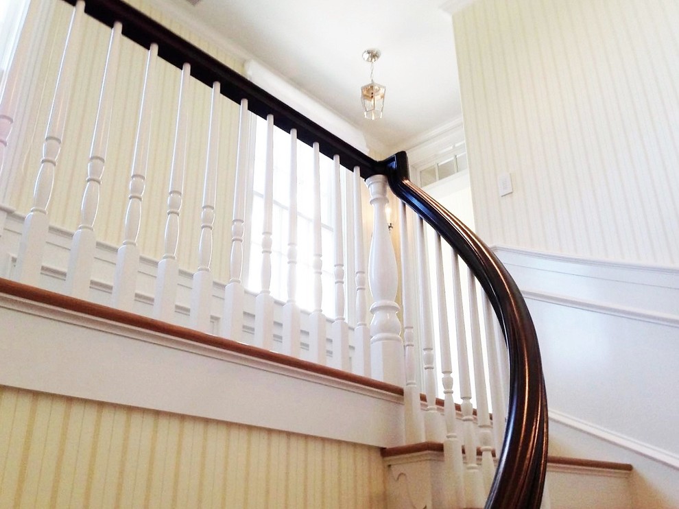 Retro wood curved staircase in Boston with wood risers.