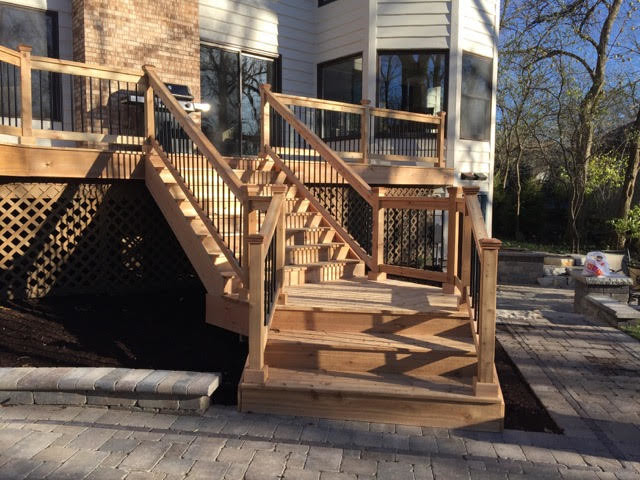 Medium sized traditional wood curved staircase in Orange County with open risers.
