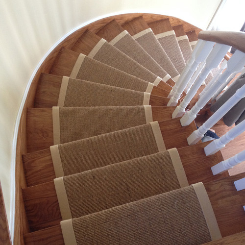 Inspiration for an expansive modern wood curved wood railing staircase in Toronto with wood risers.