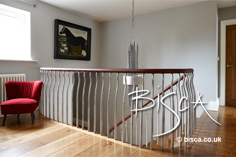Inspiration for a mid-sized modern wooden curved staircase remodel in Other with wooden risers