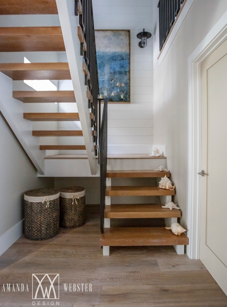 Photo of a coastal wood floating staircase in Jacksonville with open risers.