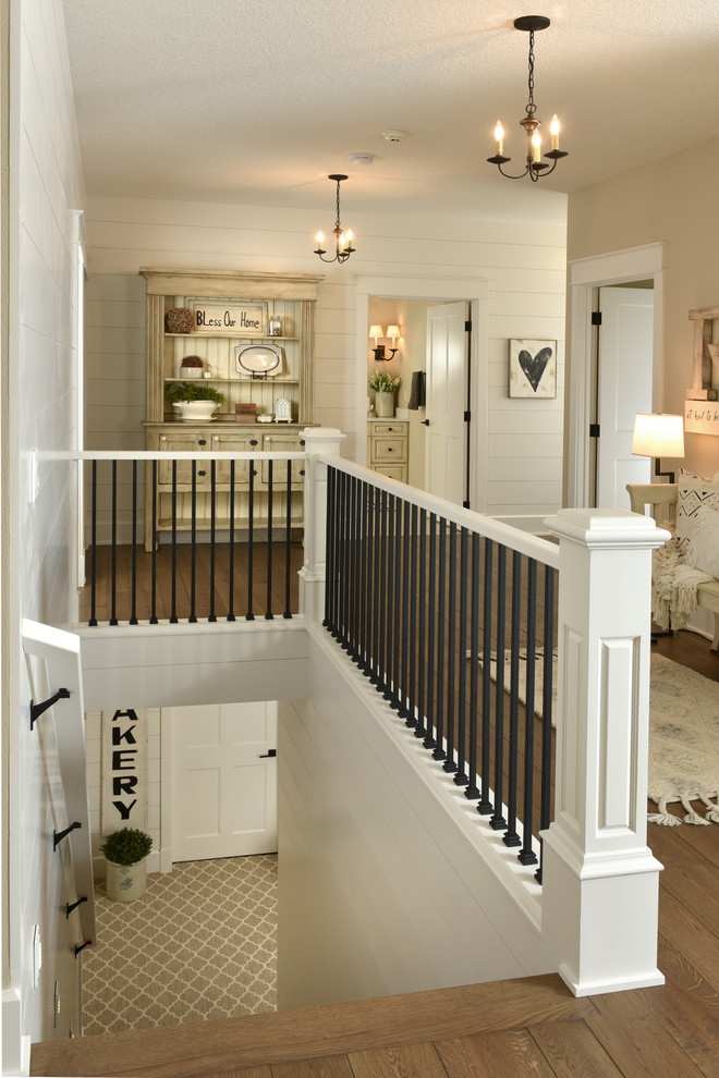Photo of a traditional staircase in Other with feature lighting.