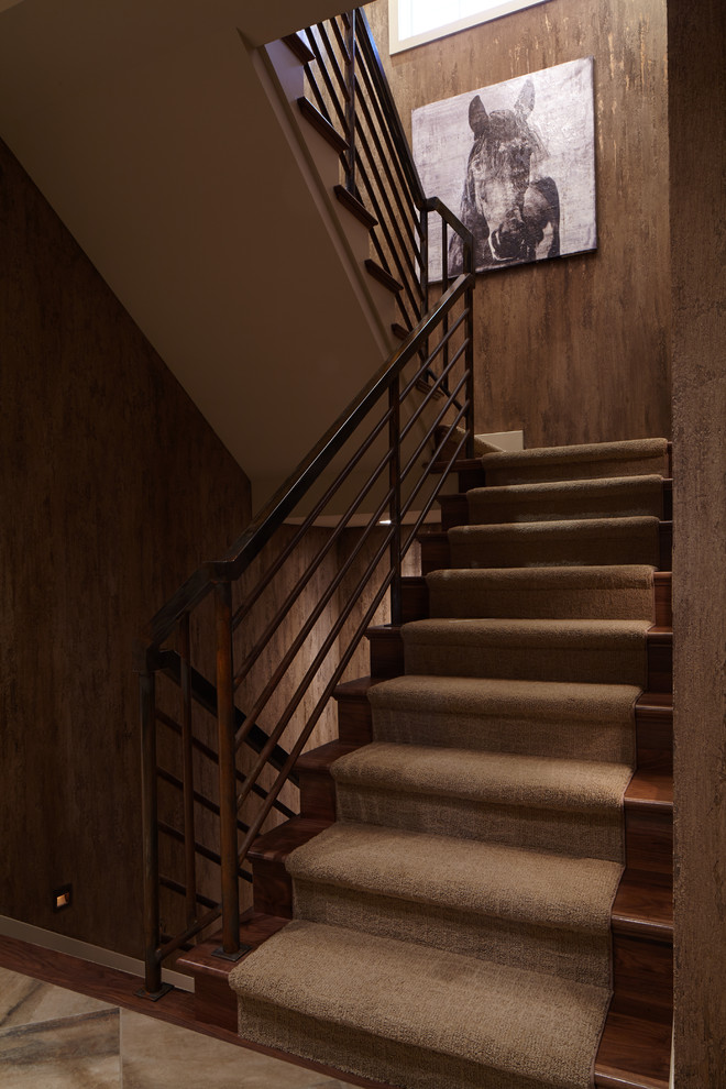 This is an example of a large classic carpeted u-shaped staircase in Omaha with carpeted risers.
