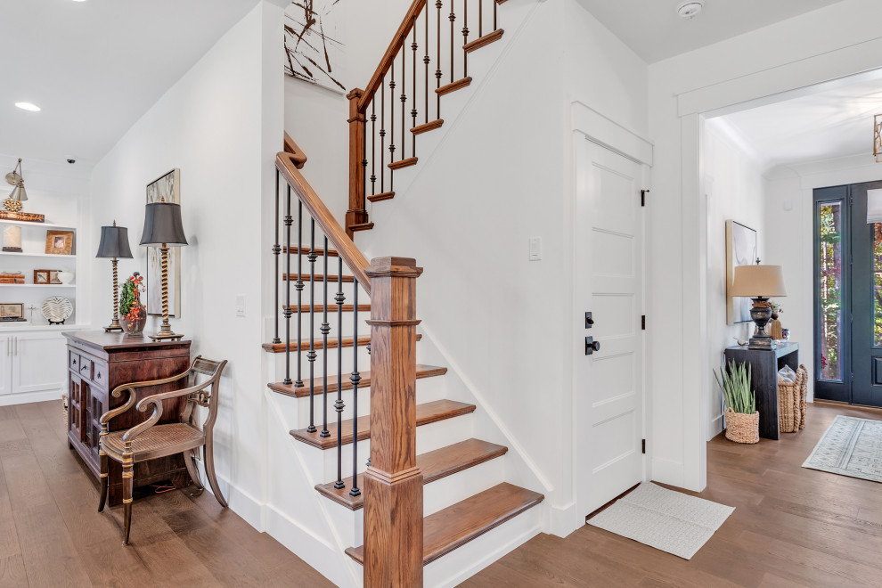 Inspiration for a mid-sized craftsman wooden u-shaped mixed material railing staircase remodel in Other with wooden risers