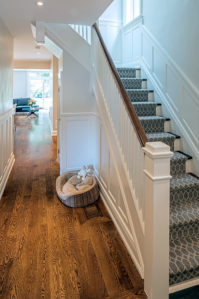 Inspiration for a medium sized traditional wood l-shaped staircase in Toronto with painted wood risers.