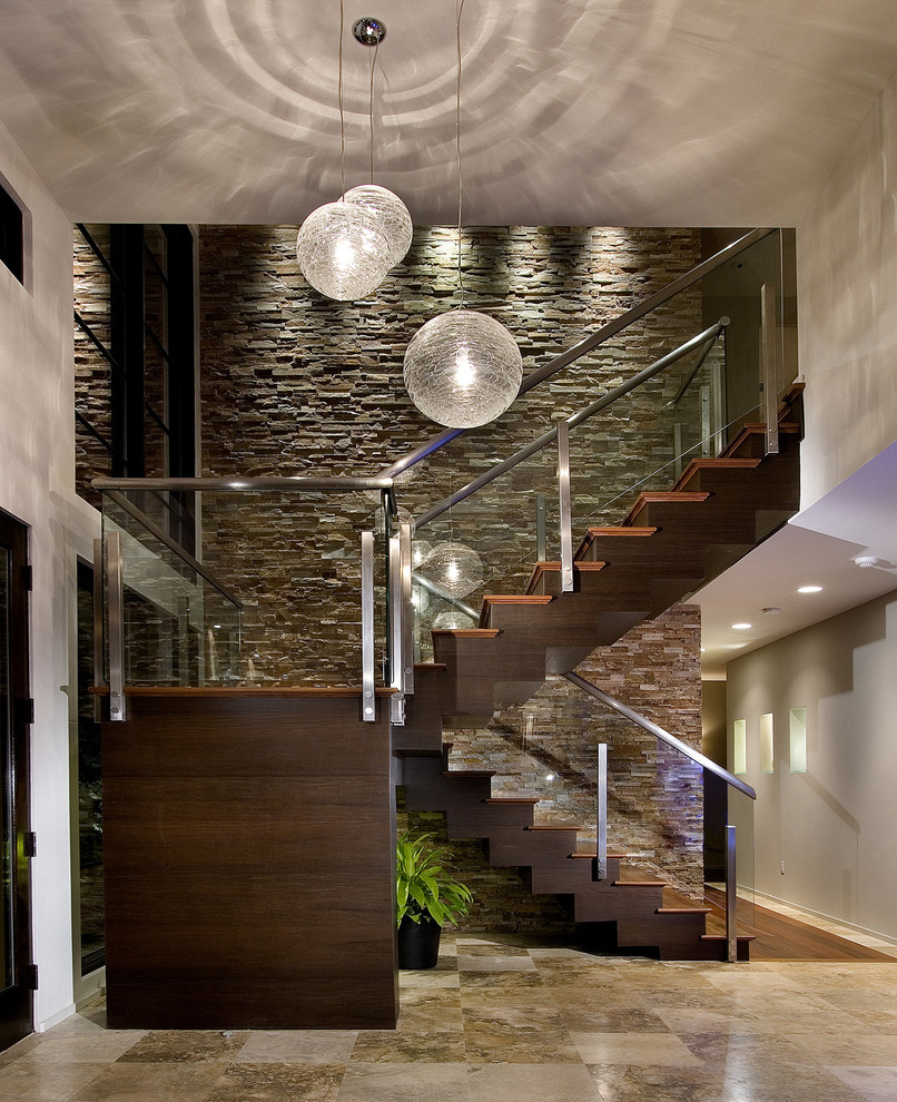 На фото: лестница в современном стиле с деревянными ступенями и стеклянными перилами