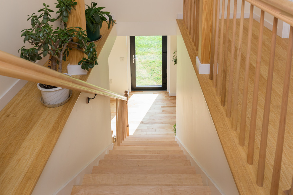 Inspiration for a contemporary wood straight wood railing staircase in Burlington.