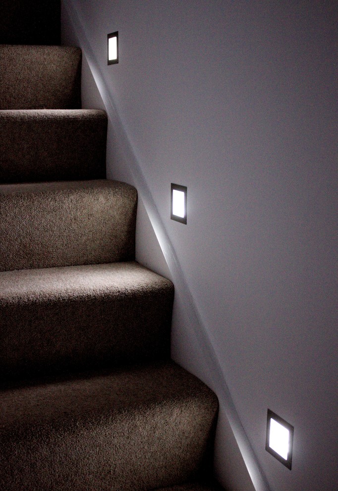 Photo of a small contemporary carpeted u-shaped staircase in Other with carpeted risers.