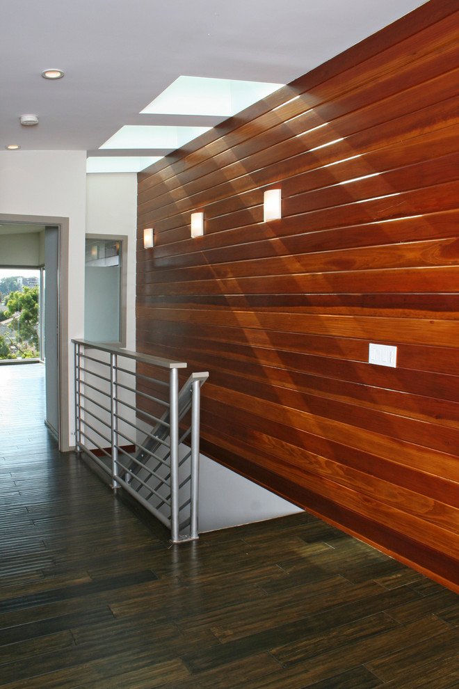 This is an example of a medium sized contemporary wood straight staircase in Los Angeles with wood risers.