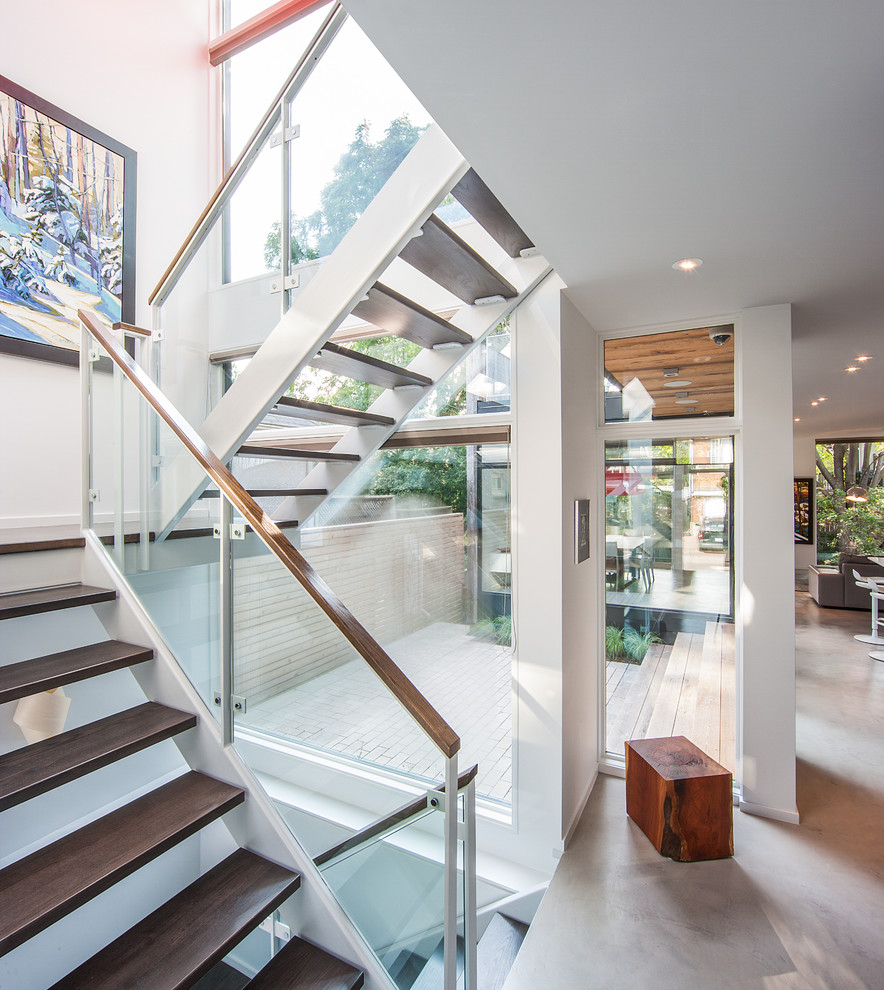 Photo of a contemporary wood u-shaped staircase in Ottawa with open risers.