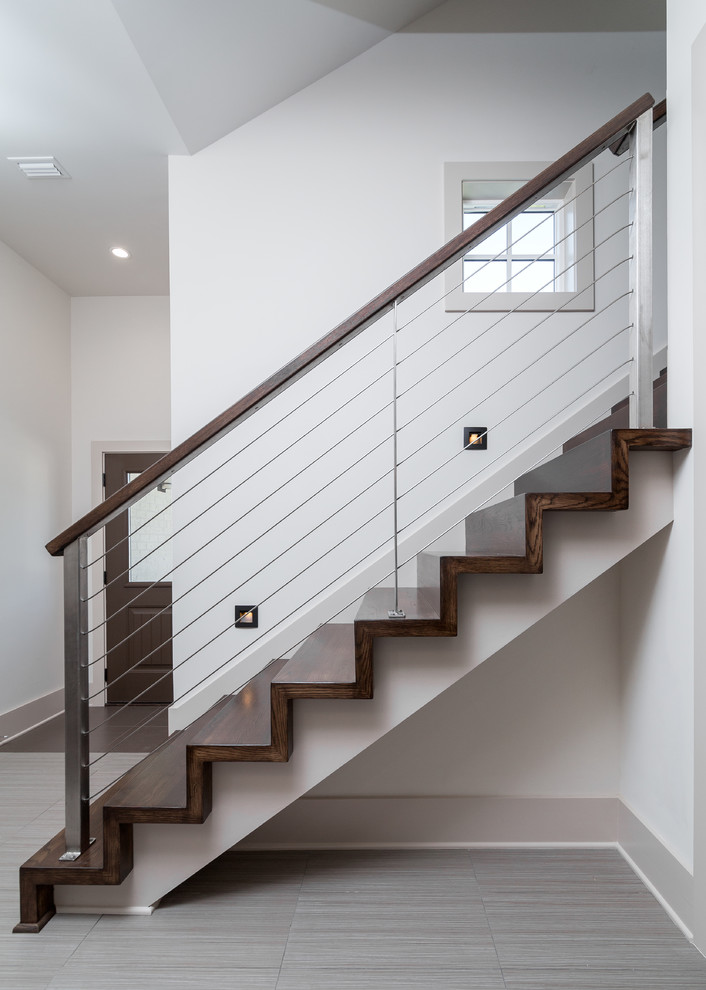 Large contemporary wood straight staircase in Atlanta with wood risers.