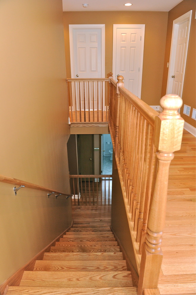Inspiration for a mid-sized timeless wooden l-shaped staircase remodel in Chicago with wooden risers