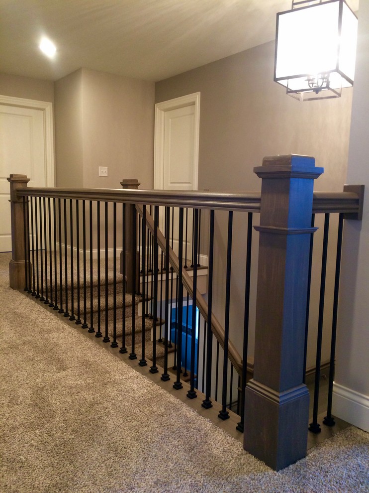 Photo of a large traditional carpeted u-shaped staircase in Chicago with carpeted risers.