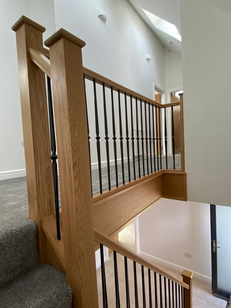 Example of a mid-sized minimalist carpeted l-shaped mixed material railing staircase design in Other with carpeted risers