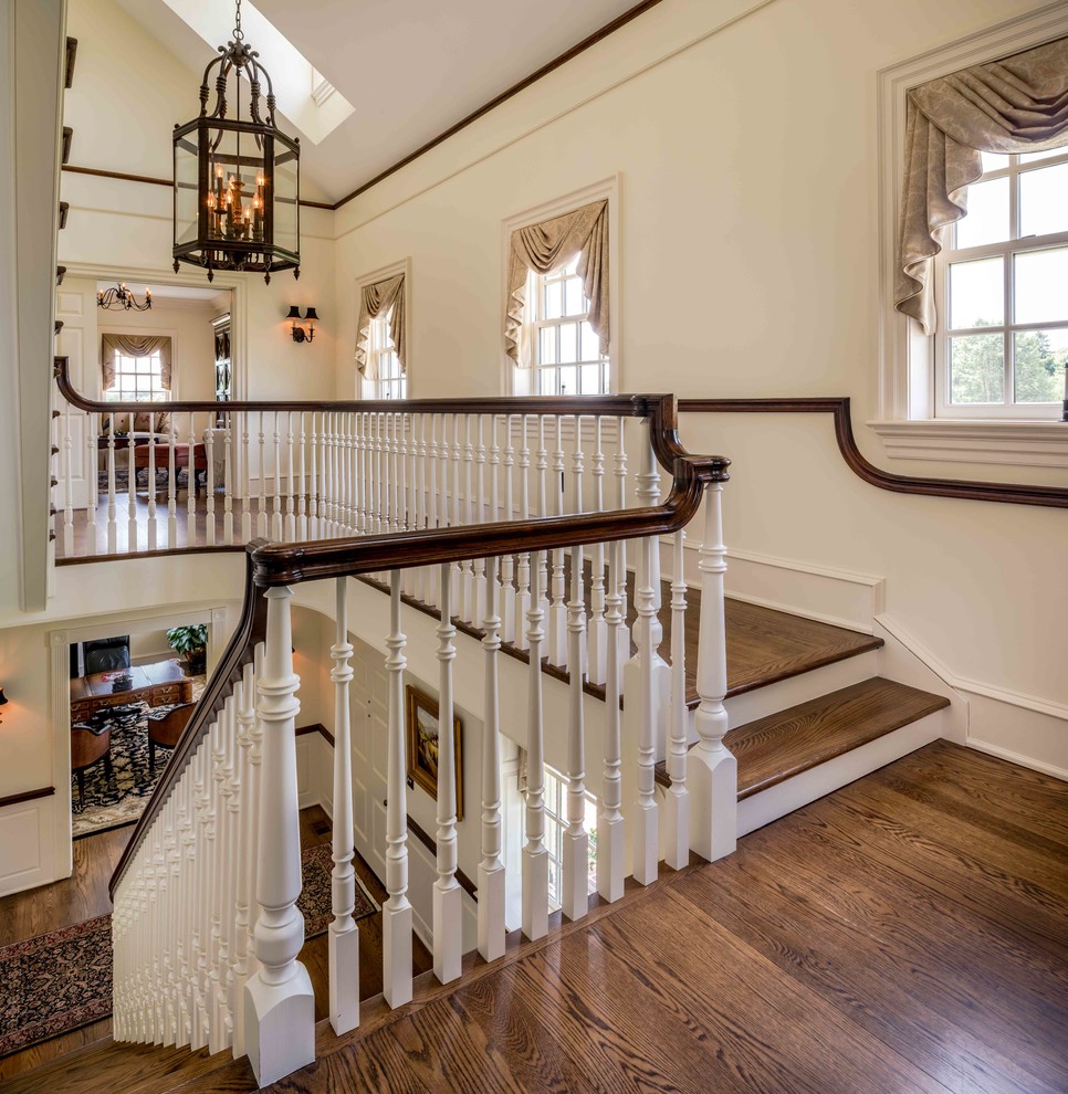 Traditional wood straight staircase in Philadelphia with painted wood risers.