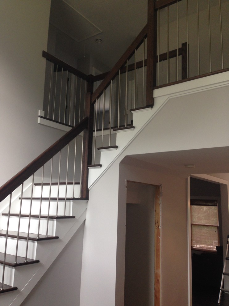 Example of a trendy wooden l-shaped staircase design in New York with painted risers
