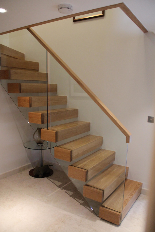 Example of a trendy wooden straight staircase design in Manchester