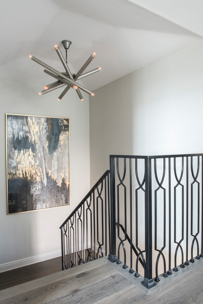 Inspiration for a mid-sized transitional wooden u-shaped metal railing staircase remodel with wooden risers