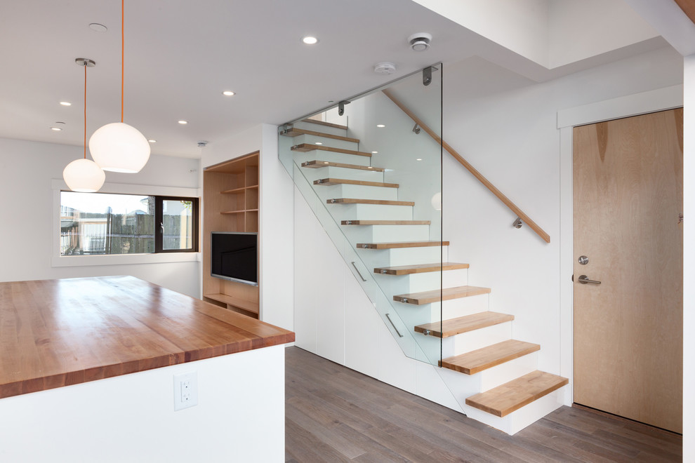 Design ideas for a contemporary wood straight staircase in Vancouver with painted wood risers.