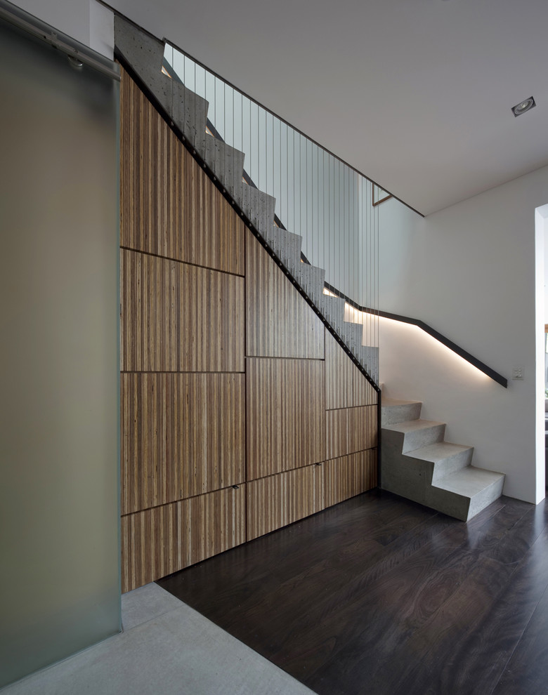 Staircase - contemporary concrete staircase idea in Sydney with concrete risers