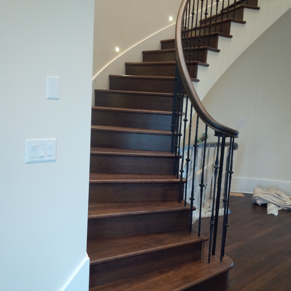 Diseño de escalera curva clásica renovada de tamaño medio con escalones de madera y contrahuellas de madera