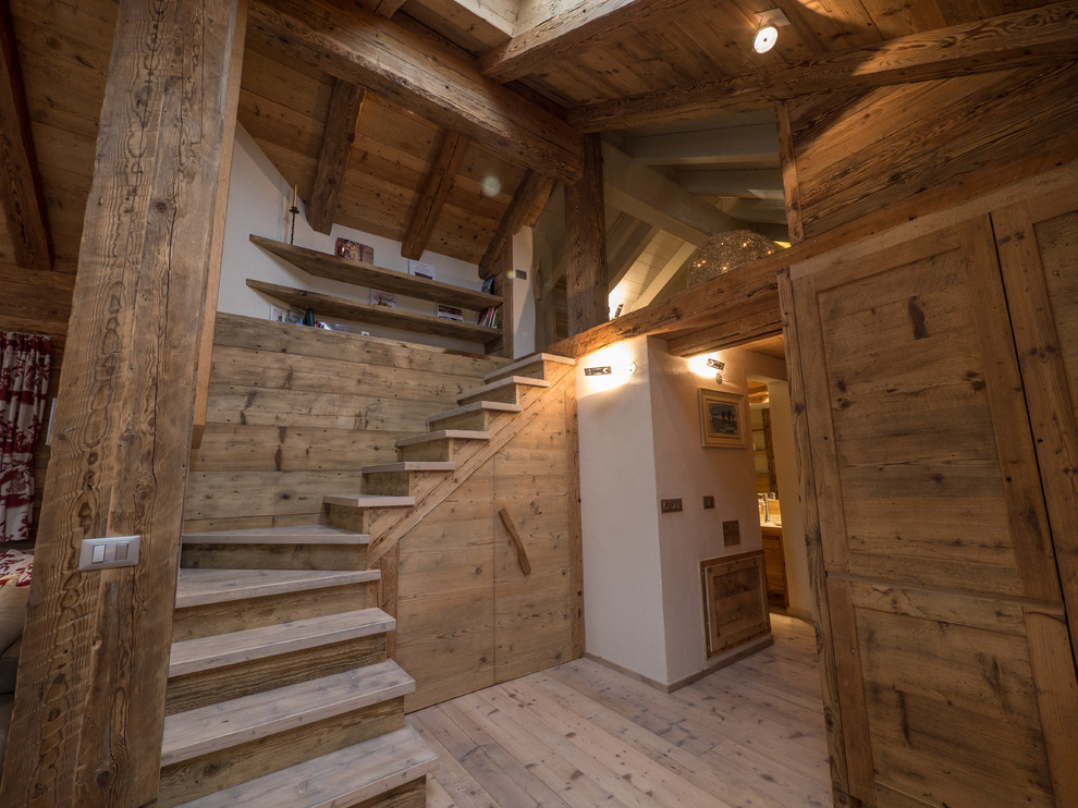 Photo of a rustic wood staircase in Miami with wood risers.