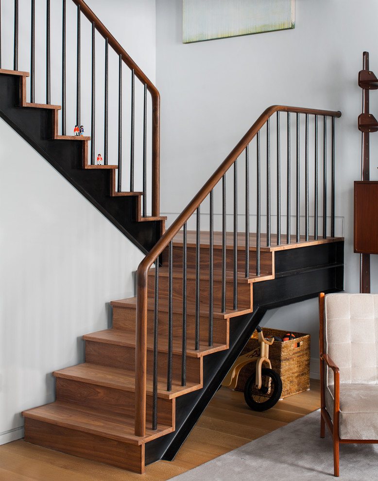 Inspiration for a contemporary wood staircase in New York with wood risers.
