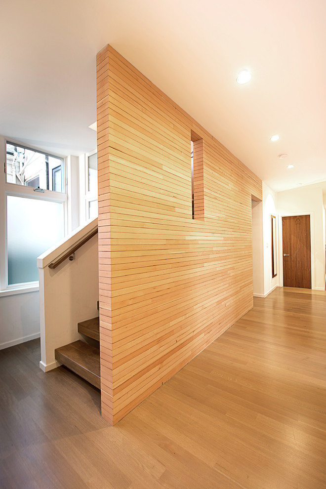 Minimalist wooden open staircase photo in San Francisco