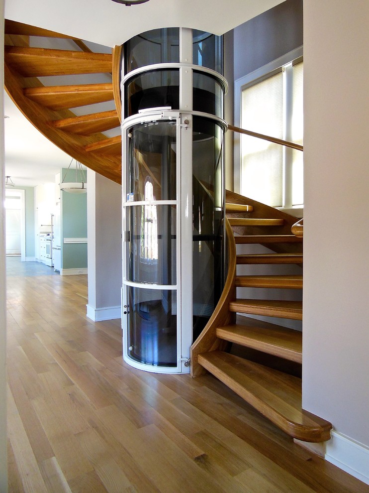 Imagen de escalera suspendida contemporánea grande con escalones de madera y contrahuellas de madera
